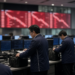 Asian trading floor at Friday cash close with a steep red descending board, as Nikkei and Kospi finish lower after recovering from a sharper open.