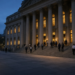 Office workers leave the New York Stock Exchange steps at dusk after the cash close.