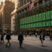 Wall Street cash open: pedestrians on the exchange plaza as a green ticker wall lights the glass facade, after a hot-core CPI print and an oil fade.