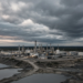 Northern Canadian heavy-oil industrial complex under a dramatic cloudy sky, suggesting Clearwater oil-sands operations.