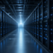 AI data-center aisle lined with server racks and blue status lights, suggesting advanced computing infrastructure without AGI-as-fact claims.