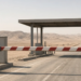 A closed desert border crossing with the barrier down after Iraq shut Shalamcheh.