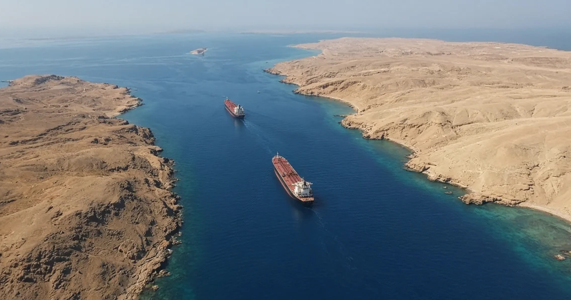 Two tankers in a narrow arid chokepoint between desert coasts (Bab el-Mandeb / Perim geography).