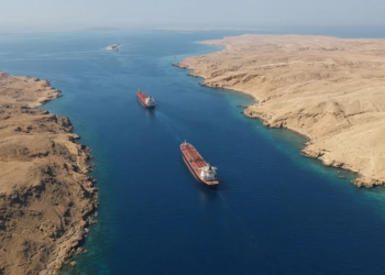 Two tankers in a narrow arid chokepoint between desert coasts (Bab el-Mandeb / Perim geography).