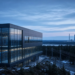 Nordic data center beside distant civilian nuclear cooling towers, suggesting Google Finland AI CapEx paired with Fortum nuclear power without logos or euro amounts on image.