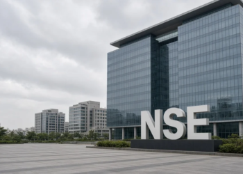 Monument NSE letters on a plaza in front of a modern exchange campus.