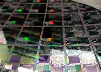 Semiconductor wafer in microelectronics manufacturing light, suggesting chip M&A and edge-AI silicon.