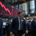 Wall Street trading floor with a steep red descending market board, capturing risk-off trading after hot inflation data and oil above $100.