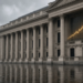 Classical London finance facade in the rain with an ascending yield curve glow, reflecting UK gilt yields at multi-year highs.