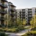 Modern multifamily apartment courtyard with balconies and landscaped paths, illustrating an all-stock REIT merger of middle-market rental portfolios.