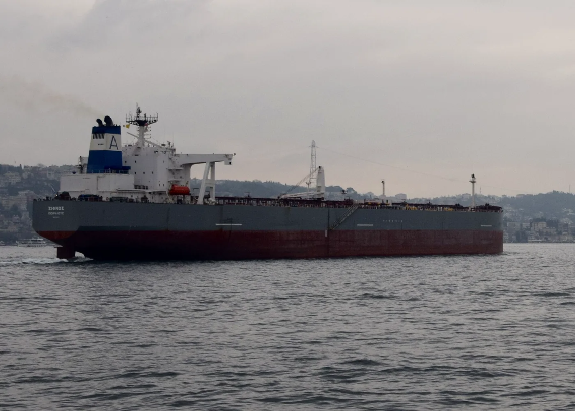 Crude oil tanker in a strait under open sky, illustrating Hormuz shipping and cargo-insurance cost pressure.