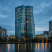 Frankfurt financial skyline and river at blue hour, conveying European Central Bank institutional policy atmosphere.