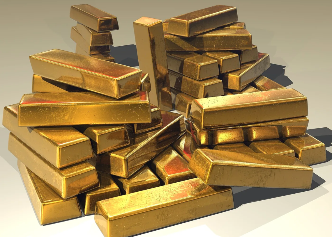 Gold bullion bars in warm light, suggesting gold price strength; last prints are not settles.
